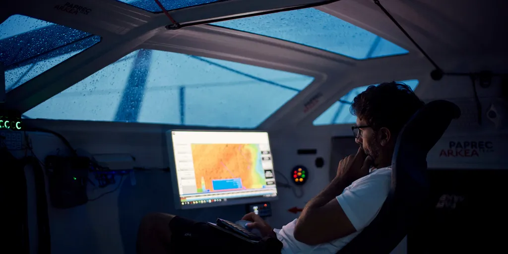 Yoann Richomme working on the weather aboard Paprec Arkéa