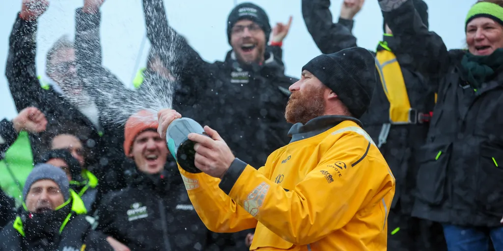 LES SABLES D'OLONNE, FRANCE - JANUARY 31, 2025 : GUYOT Environnement - Water Family skipper Benjamin Dutreux (FRA)) is celebrating with champagne at pontoon after taking 10th place in the Vendee Globe, on January 31, 2025 in Les Sables d'Olonne, France - (Photo by Lloyd Images / Alea)