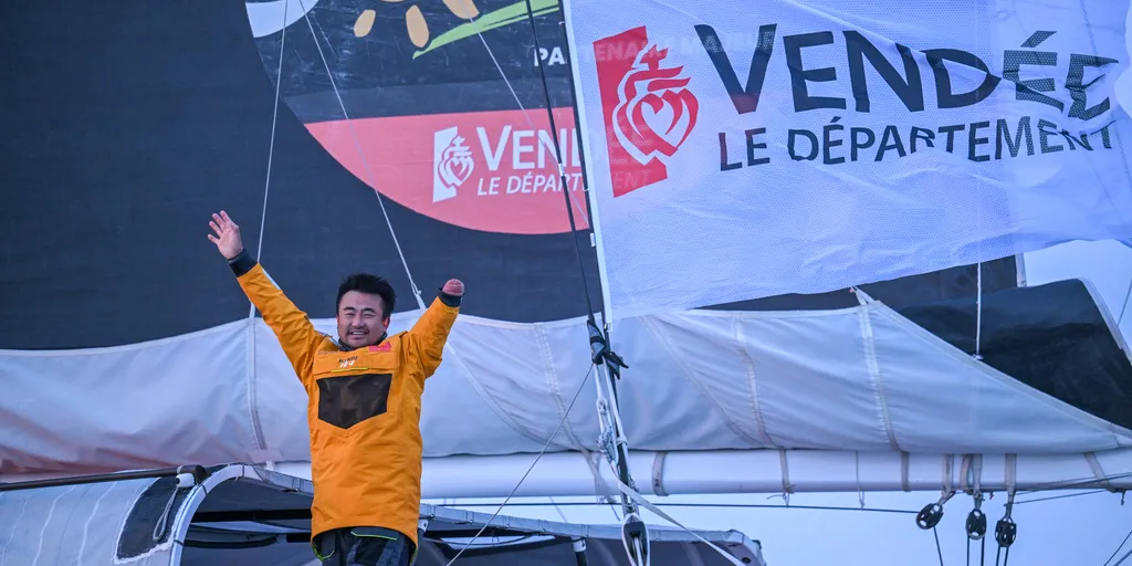 LES SABLES D’OLONNE, FRANCE - FEBRUARY 18, 2025 : Singchain Team Haikou skipper Jingkun Xu (CN) is celebrating taking 30th place in the Vendee Globe, on February 18, 2025 in Les Sables d'Olonne, France - (Photo by Vincent Curutchet / Alea)