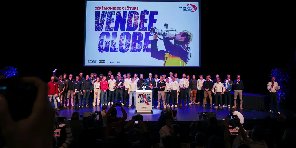 LES SABLES D'OLONNE, FRANCE - 10 MAI 2025 : Tous les skippers sont photographiés avec le vainqueur manquant MACIF Santé Prévoyance, Charlie Dalin (FRA), en arrière-plan, lors de la cérémonie de remise des prix du Vendée Globe, le 10 mai 2025 aux Sables d'Olonne, France - (Photo by Jean-Marie Liot / Alea)