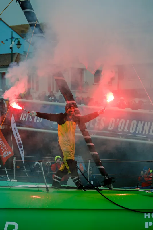 LES SABLES D'OLONNE, FRANCE - JANUARY 25, 2025 : HOLCIM - PRB skipper Nicolas Lunven (FRA) is celebrating with flares in the channel after taking 6th place in the Vendee Globe, on January 25, 2025 in Les Sables d'Olonne, France - (Photo by Anne Beauge / Alea)
