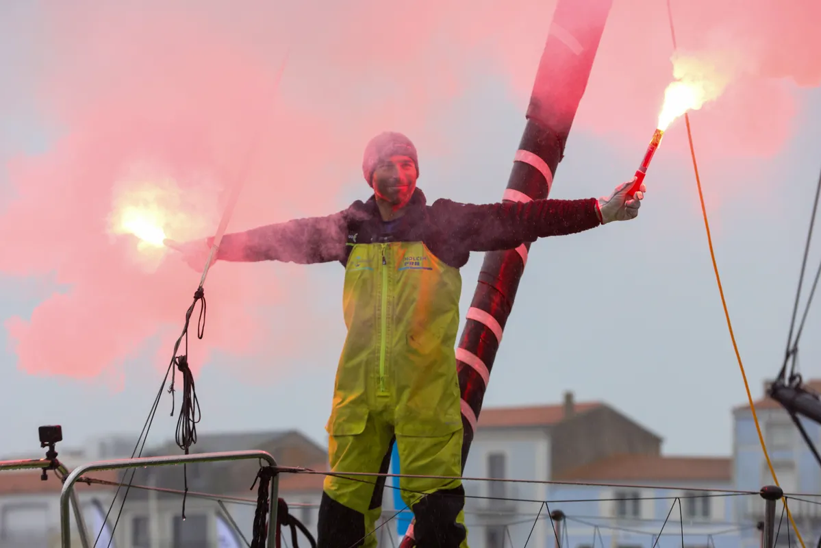 LES SABLES D'OLONNE, FRANCE - JANUARY 25, 2025 : HOLCIM - PRB skipper Nicolas Lunven (FRA) is celebrating with flares in the channel after taking 6th place in the Vendee Globe, on January 25, 2025 in Les Sables d'Olonne, France - (Photo by LloydImages / Alea)