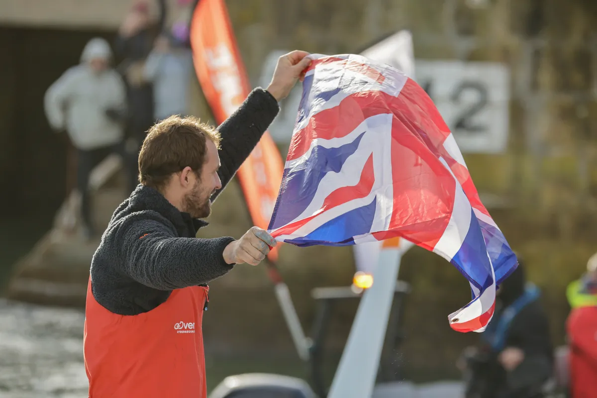 LES SABLES D'OLONNE, FRANCE - JANUARY 25, 2025 : VULNERABLE skipper Sam Goodchild (GBR) is photographed with a UK flag after taking 9th place in the Vendee Globe, on January 25, 2025 in Les Sables d'Olonne, France - (Photo by Anne Beauge / Alea)