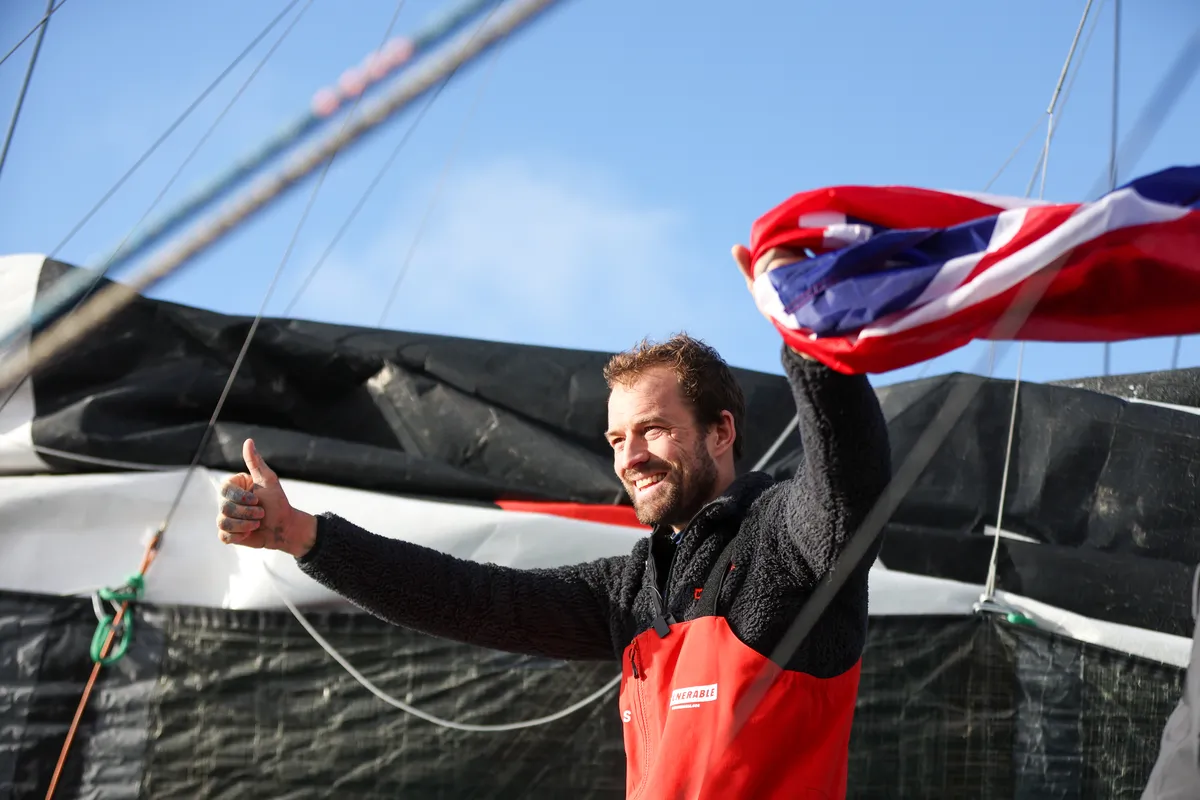 LES SABLES D'OLONNE, FRANCE - JANUARY 25, 2025 : VULNERABLE skipper Sam Goodchild (GBR) is photographed with a UK flag after taking 9th place in the Vendee Globe, on January 25, 2025 in Les Sables d'Olonne, France - (Photo by LloydImages / Alea)