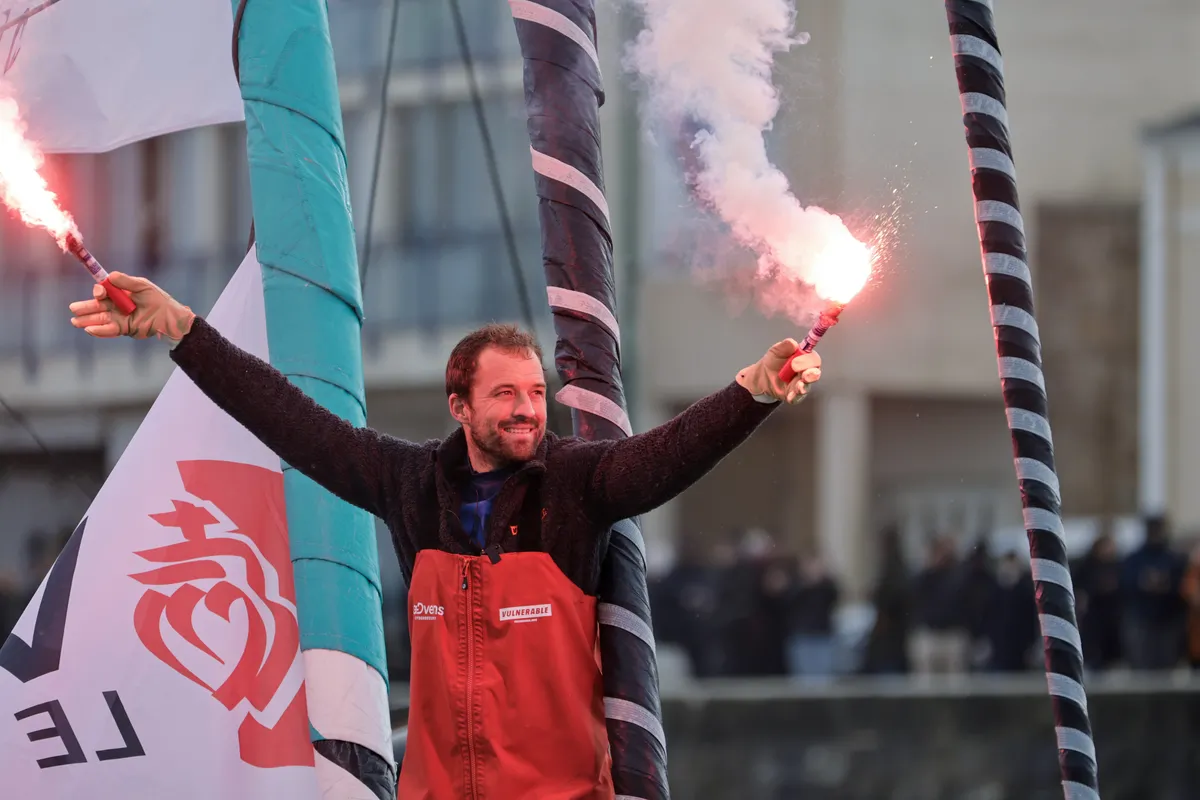 LES SABLES D'OLONNE, FRANCE - JANUARY 25, 2025 : VULNERABLE skipper Sam Goodchild (GBR) is celebrating with flares after taking 9th place in the Vendee Globe, on January 25, 2025 in Les Sables d'Olonne, France - (Photo by Anne Beauge / Alea)