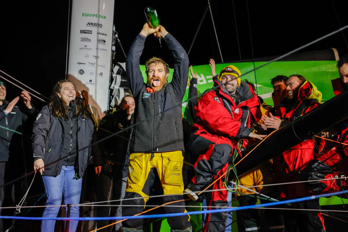 LES SABLES D'OLONNE, FRANCE - JANUARY 27, 2025 : GUYOT Environnement - Water Family skipper Benjamin Dutreux (FRA)) is celebrating with champagne after taking 10th place in the Vendee Globe, on January 27, 2025 in La Rochelle, France - (Photo by Anne Beauge / Alea)