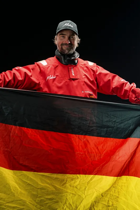 LES SABLES D'OLONNE, FRANCE - JANUARY 30, 2025 : Malizia - Seaexplorer skipper Boris Herrmann (GER) is photographed in studio with a German flag after taking 12th place in the Vendee Globe, on January 30, 2025 in Les Sables d'Olonne, France - (Photo by Olivier Blanchet / Alea)