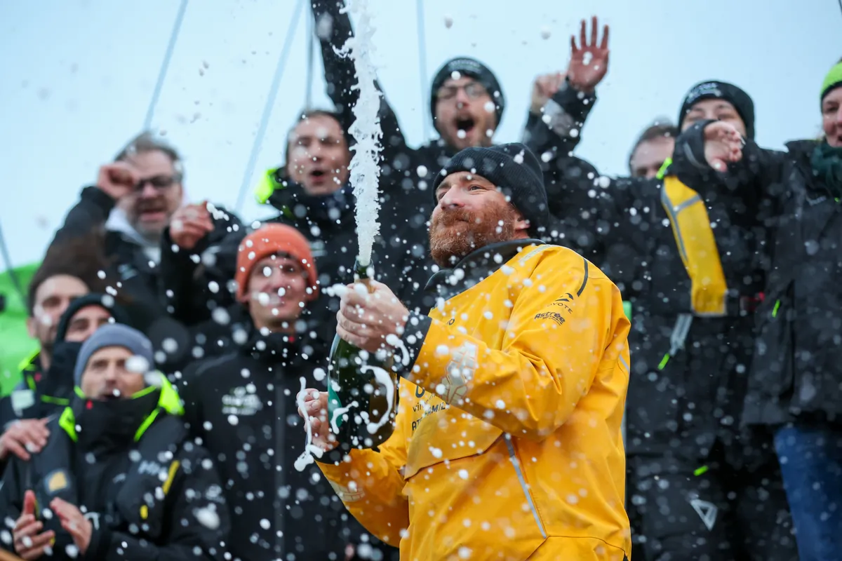 LES SABLES D'OLONNE, FRANCE - JANUARY 31, 2025 : GUYOT Environnement - Water Family skipper Benjamin Dutreux (FRA)) is celebrating with champagne at pontoon after taking 10th place in the Vendee Globe, on January 31, 2025 in Les Sables d'Olonne, France - (Photo by Lloyd Images / Alea)