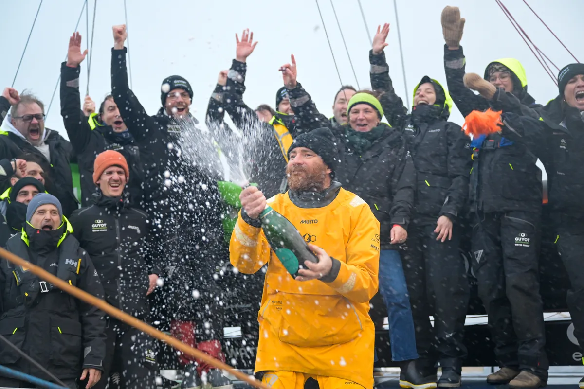 LES SABLES D'OLONNE, FRANCE - JANUARY 31, 2025 : GUYOT Environnement - Water Family skipper Benjamin Dutreux (FRA)) is celebrating with champagne at pontoon after taking 10th place in the Vendee Globe, on January 31, 2025 in Les Sables d'Olonne, France - (Photo by Olivier Blanchet / Alea)