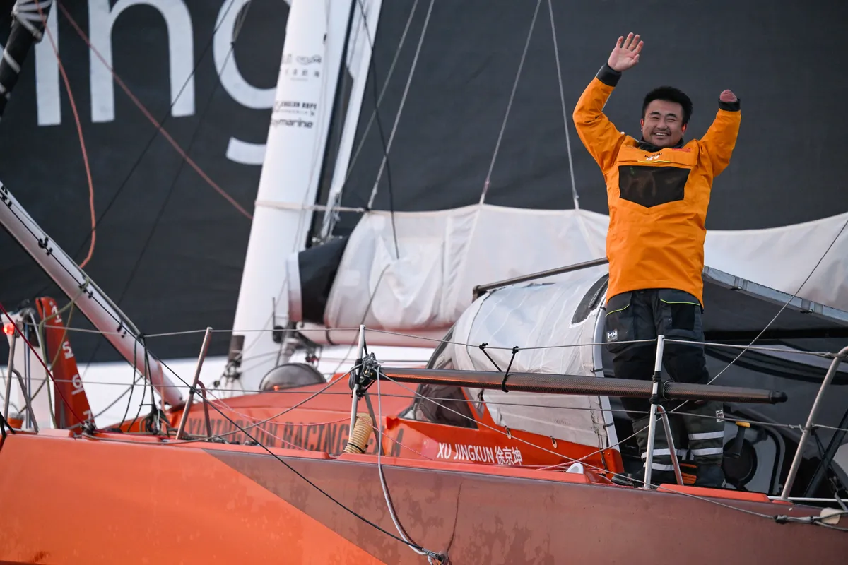 LES SABLES D'OLONNE, FRANCE - 18 FEVRIER 2025 : Le skipper de Singchain Team Haikou, Jingkun Xu (CN), fête sa 30ème place dans le Vendée Globe, le 18 février 2025 aux Sables d'Olonne, France - (Photo by Jean-Louis Carli / Alea)