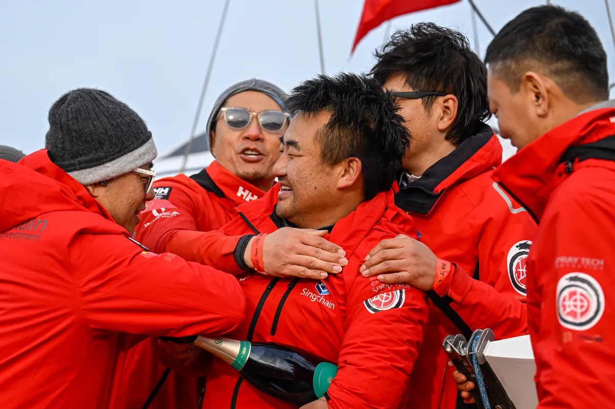 LES SABLES D’OLONNE, FRANCE - FEBRUARY 18, 2025 : Singchain Team Haikou skipper Jingkun Xu (CN) is celebrating with champagne after taking 30th place in the Vendee Globe, on February 18, 2025 in Les Sables d'Olonne, France - (Photo by Jean-Louis Carli / Alea)