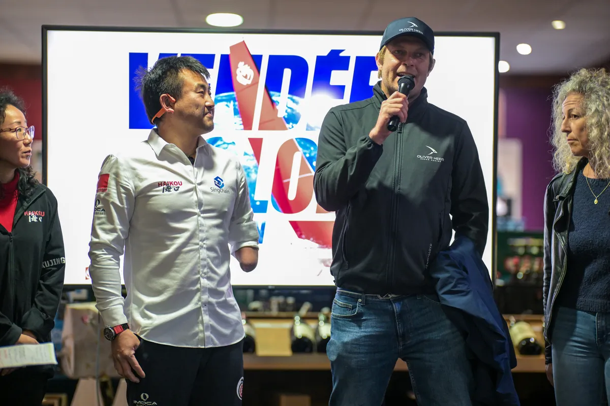 LES SABLES D'OLONNE, FRANCE - FEBRUARY 18, 2025 : Tut Gut. Sailing skipper Oliver Heer (SUI) and Singchain Team Haikou skipper Jingkun Xu (CN) are photographed at the Skippers Finishers Club of the Vendee Globe, on February 18, 2025 in Les Sables d'Olonne, France - (Photo by Vincent Curutchet / Alea)