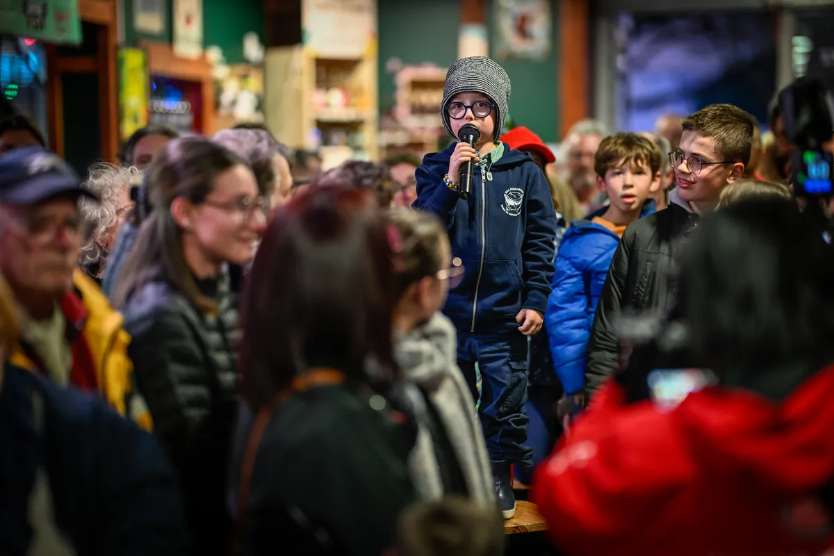 LES SABLES D'OLONNE, FRANCE - FEBRUARY 18, 2025 : Tut Gut. Sailing skipper Oliver Heer (SUI) and Singchain Team Haikou skipper Jingkun Xu (CN) are questioned by kids at the Skippers Finishers Club of the Vendee Globe, on February 18, 2025 in Les Sables d'Olonne, France - (Photo by Jean-Louis Carli / Alea)