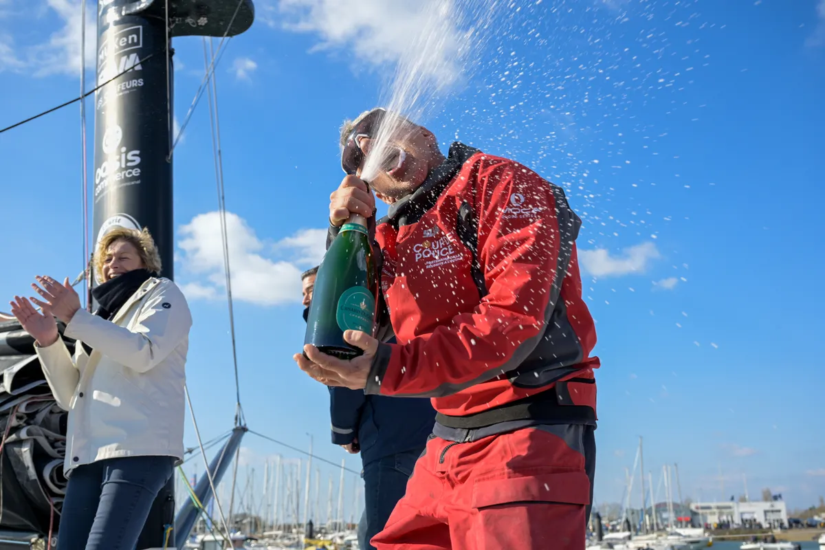LES SABLES D’OLONNE, FRANCE - MARCH 01, 2025 : Coup de Pouce skipper Manuel Cousin (FRA) is celebrating with champagne after taking 31st place in the Vendee Globe, on March 01, 2025 in Les Sables d'Olonne, France - (Photo by Olivier Blanchet / Alea)