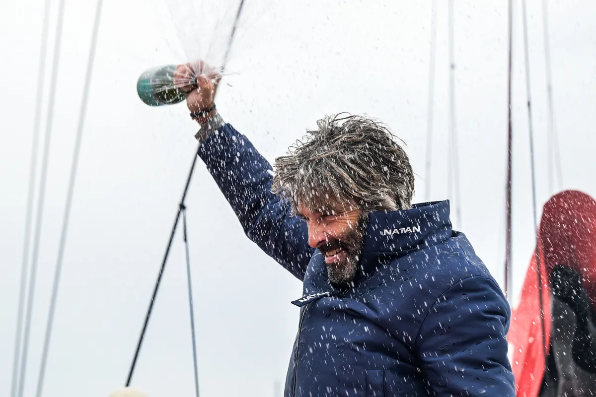 LES SABLES D’OLONNE, FRANCE - MARCH 08, 2025 : D’Ieteren Group skipper Denis Van Weynbergh (BEL) is celebrating with champagne after taking last place in the Vendee Globe, 1 day after the finish line had been closed sport-wise, hence not being classified, on March 08, 2025 in Les Sables d'Olonne, France - (Photo by Olivier Blanchet / Alea)