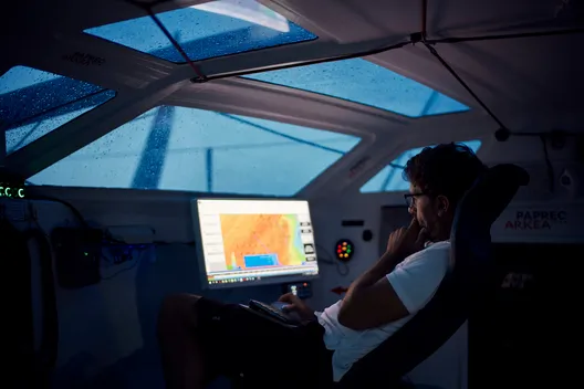 Yoann Richomme working on the weather aboard Paprec Arkéa